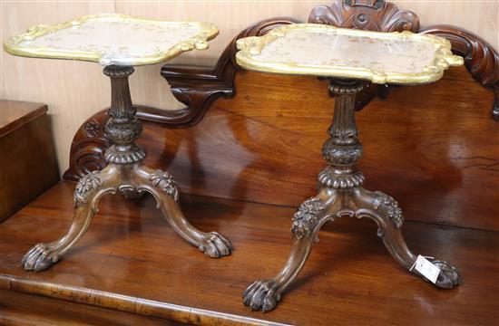 A pair of carved mahogany tripod tables, with associated gilt tops W.49cm